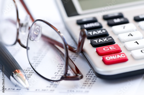 Photo: Tax calculator pen and glasses Tax calculator pen and glasses