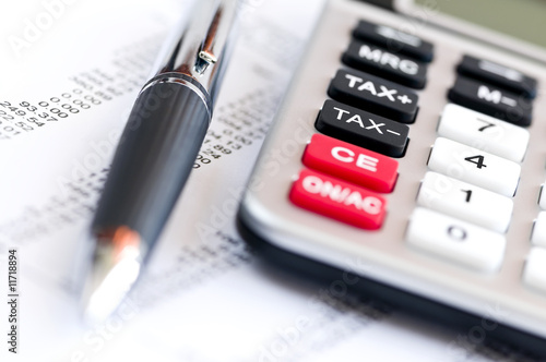 Photo: Tax calculator and pen Tax calculator and pen