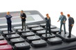 toy business man on calculator isolated toy business man on calculator isolated