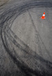 orange traffic cone and skid marks orange traffic cone and skid marks