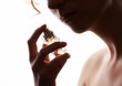 sensual woman smelling perfume, golden perfume bottle sensual woman smelling perfume, golden perfume bottle