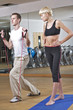 Young woman stretching with trainer
