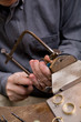 Goldsmith work in process with saw Goldsmith work in process with saw