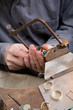 Goldsmith work in process with saw Goldsmith work in process with saw