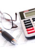 Photo: Tax calculator pen and glasses Tax calculator pen and glasses