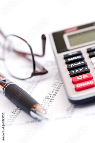 Photo: Tax calculator pen and glasses Tax calculator pen and glasses