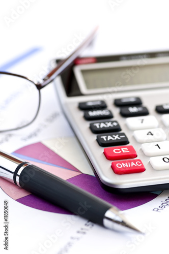 Photo: Tax calculator pen and glasses Tax calculator pen and glasses