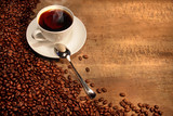 White coffee cup with beans on rustic  table. ���� ����,������� ����,���� � ���������, ������� ����