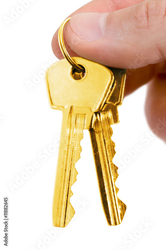 Photo: gold key in fingers gold key in fingers