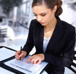 Young and smiling woman signing document