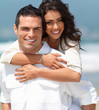 Portrait of a happy young couple having fun on the beach