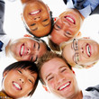 Group of business people standing in huddle, smiling, low angle