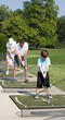 Family Practicing Golf Family Practicing Golf