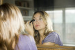 woman applying makeup to her face