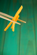 Chopsticks and yellow peppers Chopsticks and yellow peppers