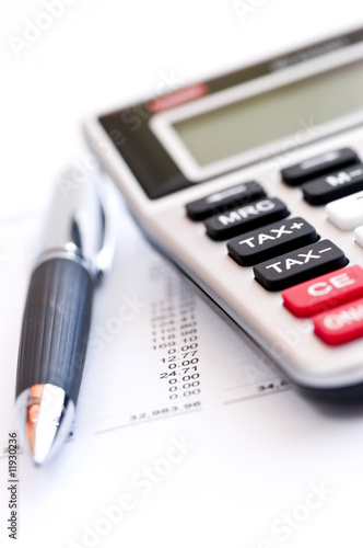 Photo: Tax calculator and pen Tax calculator and pen