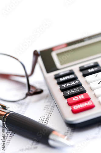 Photo: Tax calculator pen and glasses Tax calculator pen and glasses