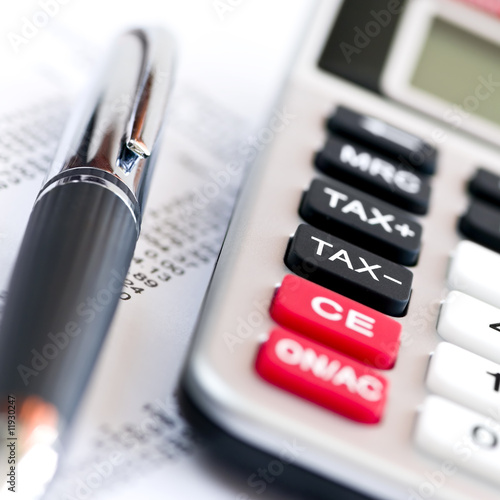 Photo: Tax calculator and pen Tax calculator and pen