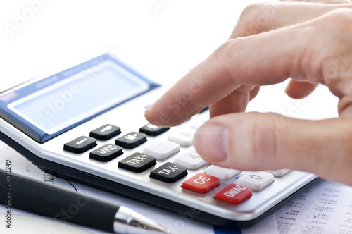 Photo: Tax calculator and pen Tax calculator and pen