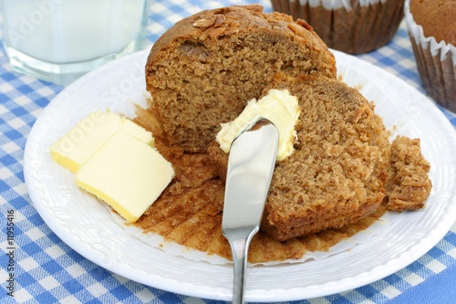 Photo: Cut oat bran muffin with butter and milk. Cut oat bran muffin with butter and milk.