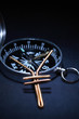 Yen sign made from wire on dark background with compass