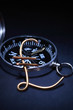 Pound sterling sign made from wire with compass