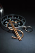 Dollar sign made from wire on background with compass