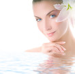 Beautiful woman with lily flower in her hair reflected in water Beautiful woman with lily flower in her hair reflected in water