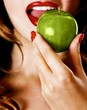 Woman eating a green apple