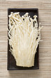 enokitake mushrooms in wooden dish (overhead view)