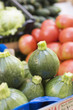 rondini (round courgettes) in a crate at a market