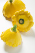 three yellow patty pan squashes