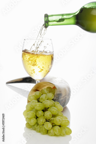 Photo: pouring a glass of white wine pouring a glass of white wine