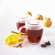 mulled wine in glass mugs, orange peel, spices and apples