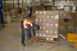Photo: warehouse worker checking damaged goods on a pallet warehouse worker checking damaged goods on a pallet