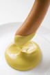 dipping a sausage in mustard