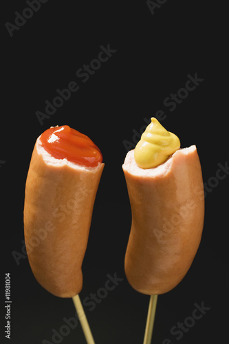 Photo: sausages with ketchup & mustard on wooden cocktail sticks sausages with ketchup & mustard on wooden cocktail sticks