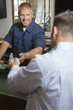 Man Paying for Repair Work