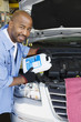 Auto Mechanic Adding Fluids to Minivan