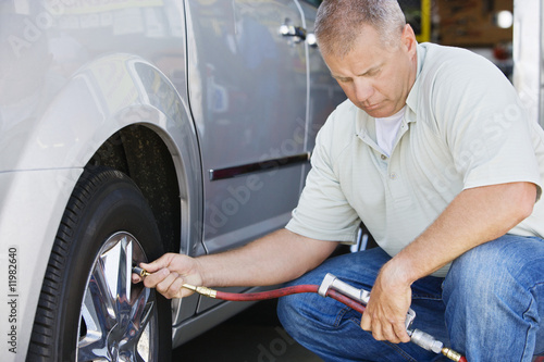 Photo: Man Filling Tires on RV Man Filling Tires on RV
