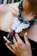 Woman wearing butterfly jewellery.
