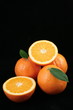 Oranges with leafs on the black background