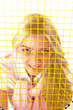 top view of smiling young woman looking through tennis racket