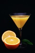 Orange juice in a glass and orange on black background