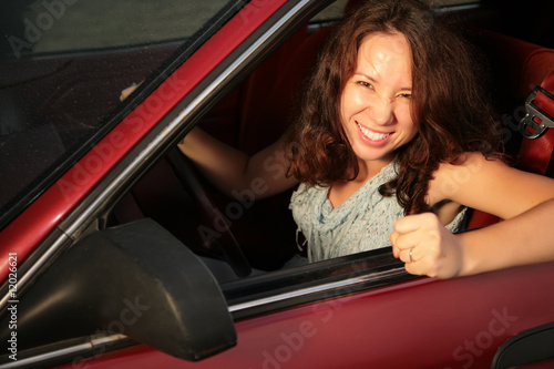 Photo: Woman in the red car Woman in the red car