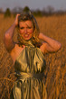 a model posing in a wheat field