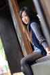 Beautiful young lady setting on the japanese wooden door