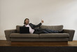 Businessman lies on the sofa