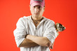 man with golden trophy on red background