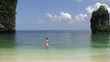 Young man taking jump in clear blue water